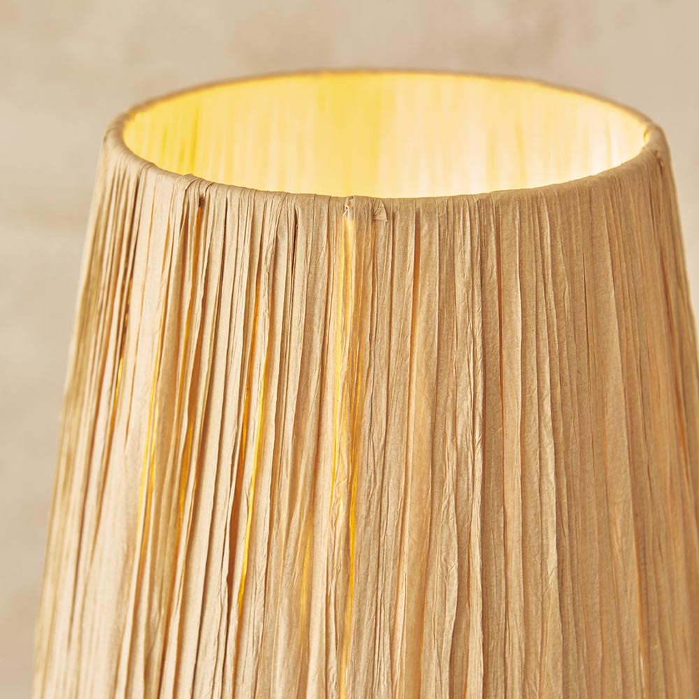 Close-up of the Endon Danemont table lamp showing its illuminated hand-wrapped natural raffia tapered shade against a neutral background.