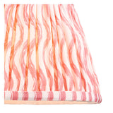 Close-up of the Endon Aldworth Ripple table lamp shade, showing the handmade pleated faux linen in a coral pink and orange ripple print with taped edge.