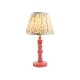 Endon Aldworth Leaf table lamp with pink clay turned wood spindle base and pleated green leaf-print fabric shade on a white background.