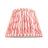 Aldworth Ripple pleated coral pink lampshade with wavy stripe pattern, shown alone on a plain white background.