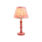 Aldworth Ripple Table Lamp with a coral pink turned spindle base and a handmade ripple-print fabric shade in pink and coral tones, brass fitting.