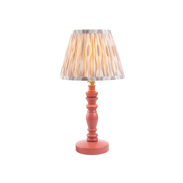 Endon Aldworth Ikat table lamp with pink clay turned wooden spindle base, brass lampholder and pleated ikat shade in grey and natural tones.