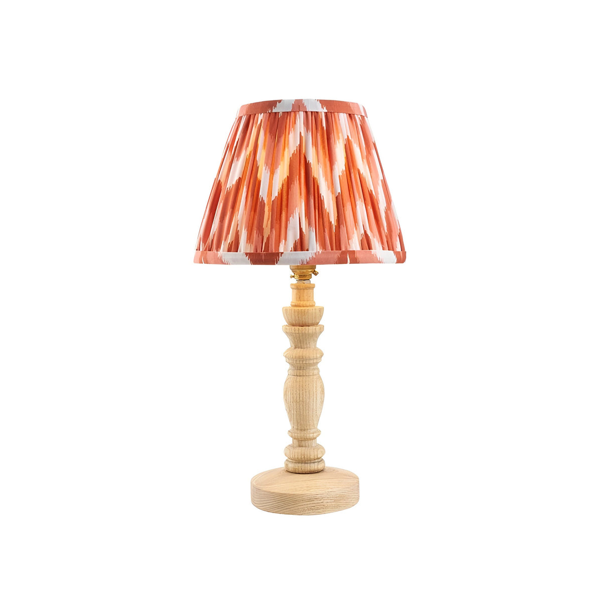 Endon Aldworth table lamp with hand-turned natural wood spindle base, brass B22 holder and pleated orange zigzag faux silk shade, on a white background.