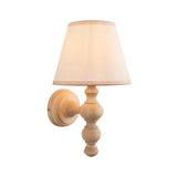 Aldworth Ivy Wall Light in Natural finish, a single turned wood wall light with tapered ivory fabric shade on a plain white background.