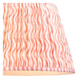 Close-up of the Endon Ashwood floor lamp's 40cm Ripple shade, a gathered pleat faux linen in coral pink wave print with taped striped edge.