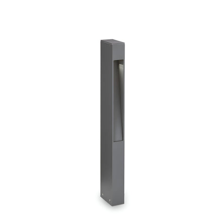 Introducing the Nest Outdoor Bollard Light - Grey, a sleek and modern illumination solution crafted from powder-coated aluminum. This minimalist rectangular light fixture is finished in matte grey and features a distinctive cut-out section that casts a soft glow against its pure white backdrop.