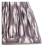 Close-up of the Bevbury Ikat wall light's pleated fabric shade in grey and white ikat pattern, showing gathered folds and trim edge.