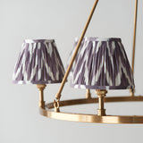 Close-up of Endon Bevford Zigzag 6 Light Pendant showing two pleated pearl grey zigzag fabric shades on an aged brass hoop frame with B22 holders.
