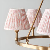 Close-up of Endon Bevford Leaf 6 Light Pendant in peach, showing pleated faux linen shades with pink leaf print on an aged brass hoop frame.