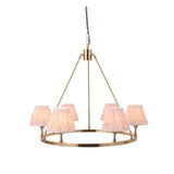 Endon Bevford Leaf six-light hoop pendant in aged brass with tapered pleated peach faux linen shades, suspended on a black chain against a white background.