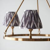 Bevford Zigzag 3 Light Pendant in grey, close-up of pleated fabric shades on brass B22 holders with circular hoop frame, light grey background.