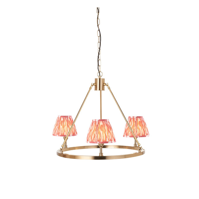 Bevford Ikat 3 Light Pendant in Coral, a hoop pendant with three tapered coral Ikat fabric shades on an aged brass frame and chain, shown on a white background.