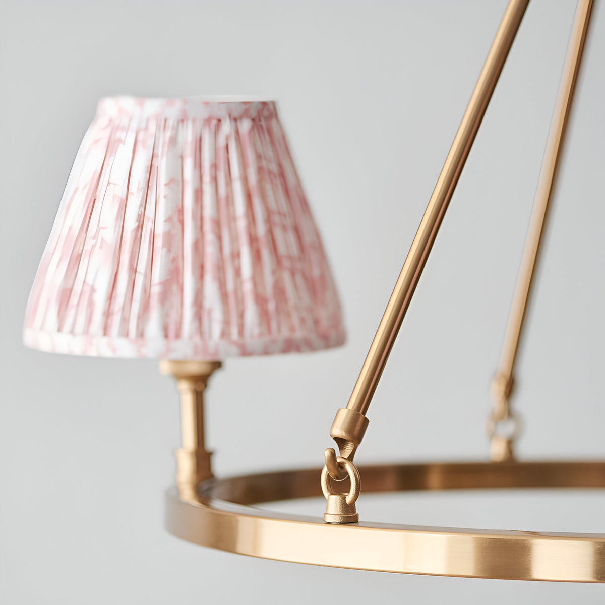 Close-up of Endon Bevford 3 Light Pendant in peach, showing an aged brass hoop with a pleated pink patterned fabric shade on a B22 lamp holder.