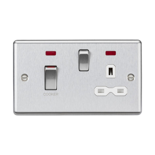 The 45A DP Switch & 13A Socket Neons – Brushed Chrome (White Insert, Rounded Edge) includes a 45A Cooker switch and dual outlet, complemented by two red indicator lights above the switches that enhance its contemporary and minimalist design.