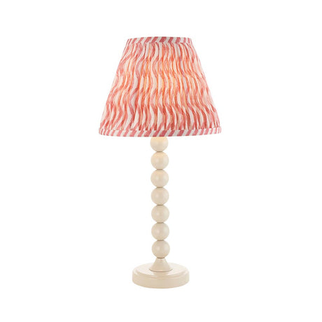 Endon Brenleigh Ripple table lamp with stacked-sphere white gloss metal base and pink and white pleated faux linen shade, on a plain background.