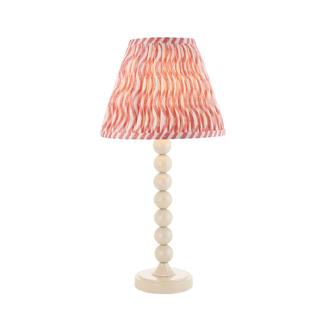 Endon Brenleigh Ripple table lamp with stacked-sphere white gloss metal base and pink and white pleated faux linen shade, on a plain background.