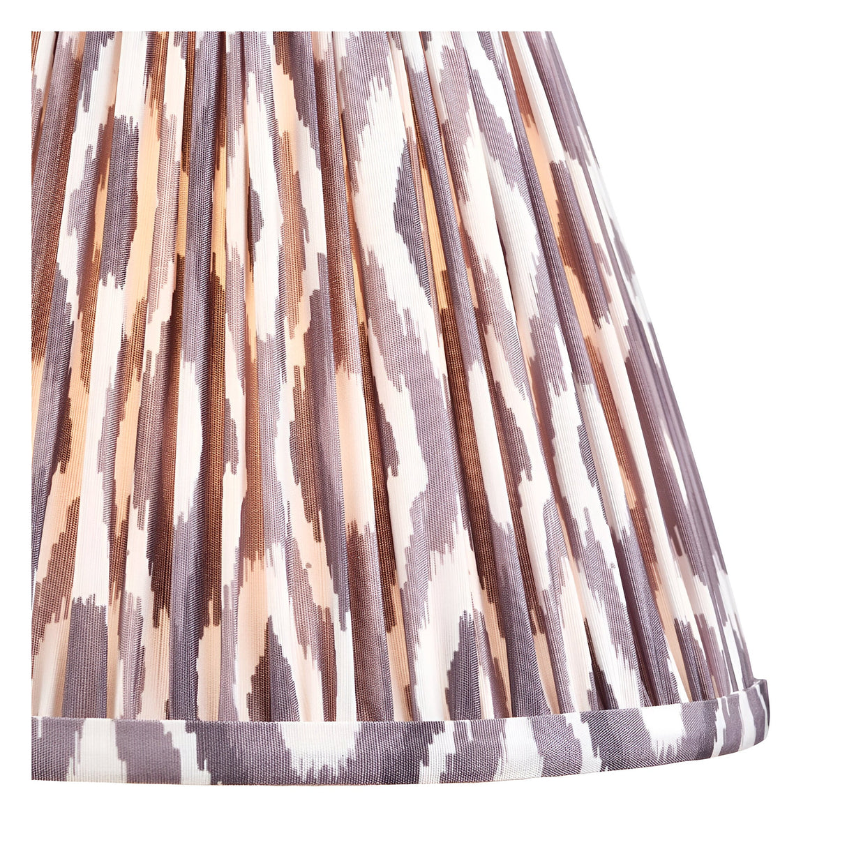 Close-up of the Brenleigh Ikat Table Lamp's pleated 25cm shade in white, grey and brown Ikat-print faux silk with a folded trim edge.