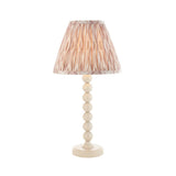 Brenleigh Ikat table lamp with white gloss stacked-sphere metal base and pleated natural Ikat-print fabric shade, on a plain white background.
