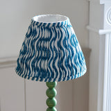 Endon Brenleigh Ripple table lamp with a pleated blue and white wave-print fabric shade above a glossy green stacked-sphere base.