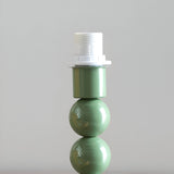 Brenleigh Zigzag Table Lamp base in green, gloss-painted stacked-sphere metal design with white E14 bulb holder, shown on a plain light background.