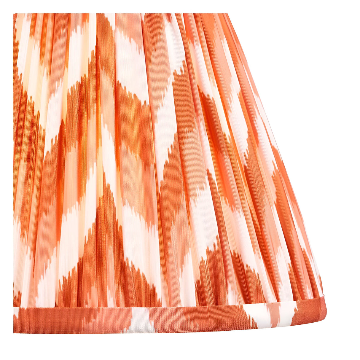 Close-up of the Brenleigh Zigzag Table Lamp's pleated fabric shade, showing an orange and cream zigzag pattern on a plain background.