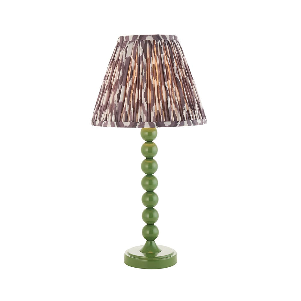 Brenleigh Ikat table lamp with a green gloss stacked-sphere metal base and pleated grey Ikat fabric shade, shown on a plain white background.
