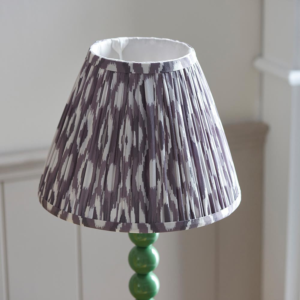 Brenleigh Ikat Table Lamp with pleated grey and white faux silk shade on a green gloss stacked-sphere metal base.