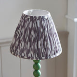 Brenleigh Ikat Table Lamp with pleated grey and white faux silk shade on a green gloss stacked-sphere metal base.