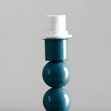 Brenleigh Ripple Table Lamp base in blue with stacked gloss-painted metal spheres and white E14 bulb holder, shown against a plain light grey background.