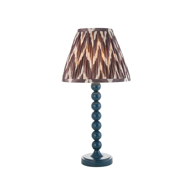 Endon Brenleigh table lamp with a blue gloss stacked-sphere metal base and grey zigzag pleated faux silk shade, on a plain white background.