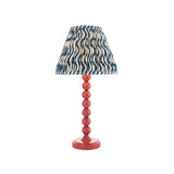 Endon Brenleigh Ripple table lamp with stacked-sphere pink gloss metal base and pleated blue ripple-print fabric shade on a plain white background.