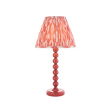 Endon Brenleigh Ikat table lamp in pink with a stacked-sphere gloss metal base and pleated Ikat faux silk shade, on a plain white background.