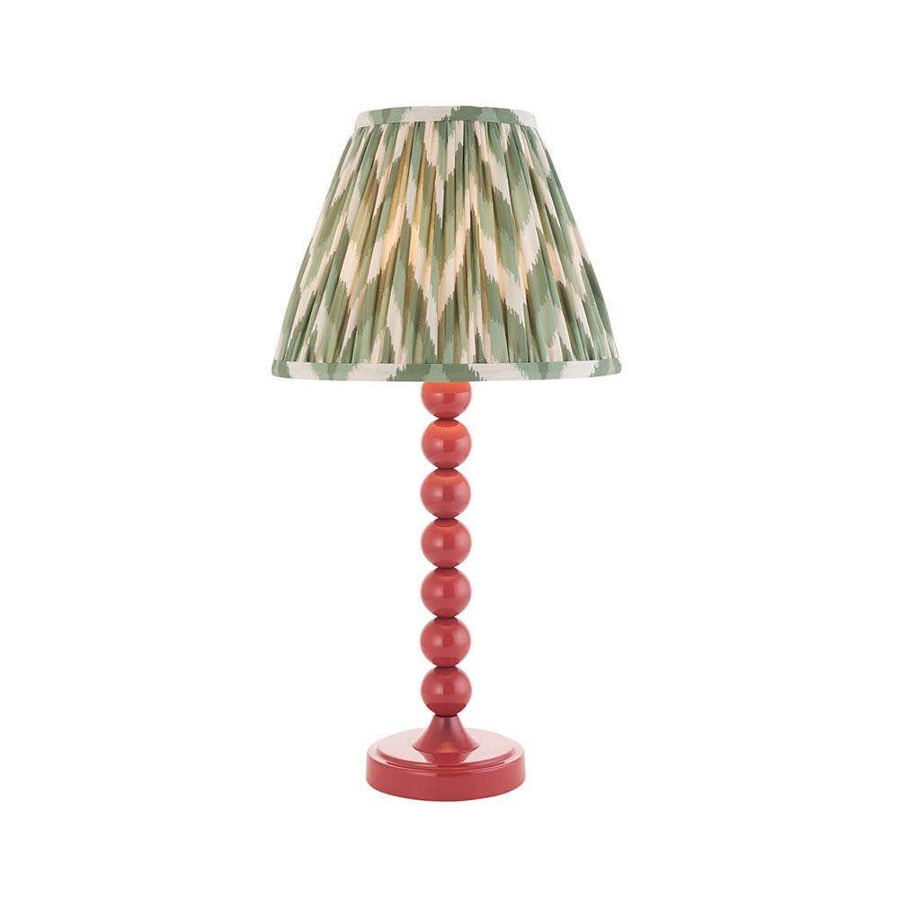 Endon Brenleigh Zigzag table lamp with pink stacked-sphere gloss metal base and green pleated zigzag-print shade, shown on a white background.