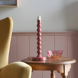 Endon Brenleigh table lamp base with stacked-sphere pink gloss metal column on a wooden side table beside a pink glass bowl in a panelled room.
