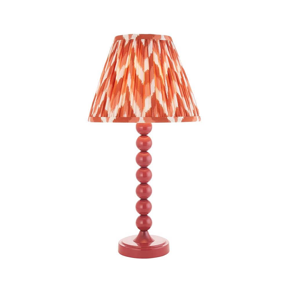Brenleigh Zigzag Table Lamp in pink, featuring a stacked-sphere gloss metal base and a pleated zigzag-print fabric shade, shown on a plain white background.
