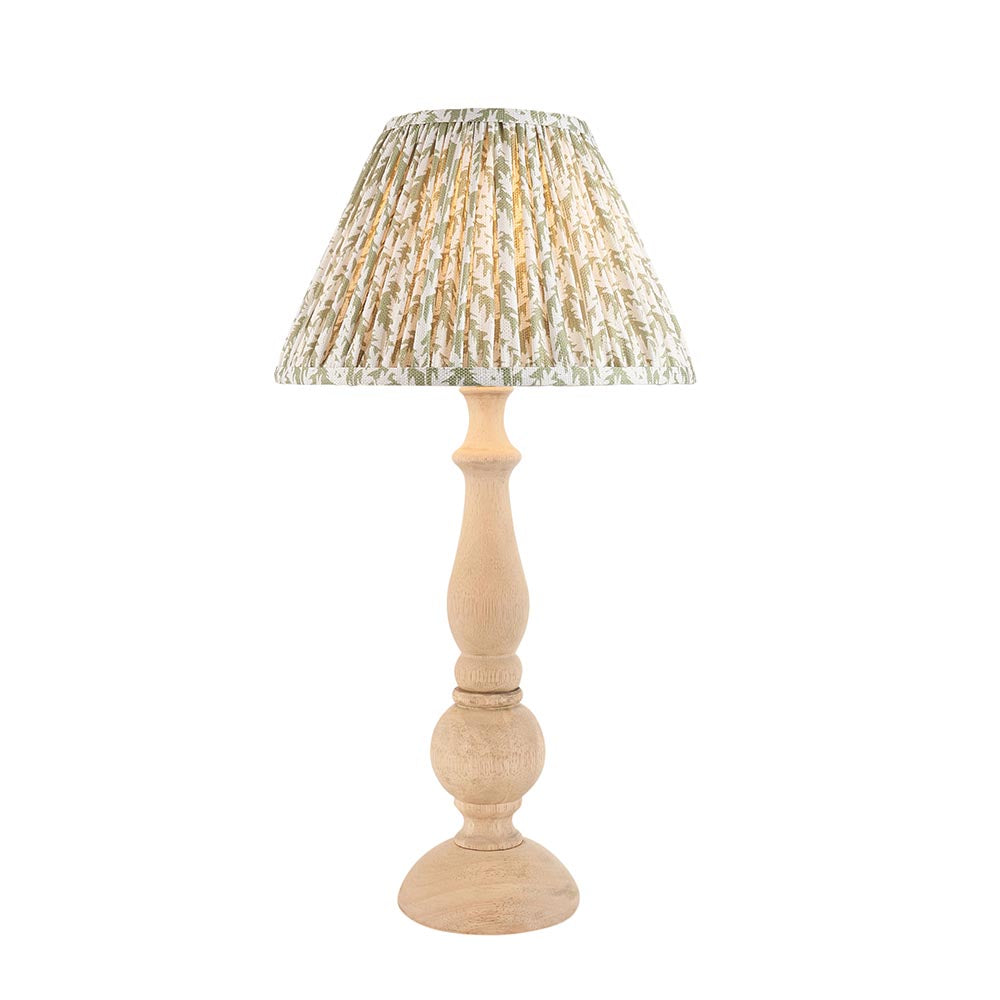 Endon Brenhurst table lamp with a hand-turned natural wood base and pleated green leaf-print fabric shade, shown on a plain white background.