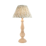 Endon Brenhurst table lamp with a hand-turned natural wood base and pleated green leaf-print fabric shade, shown on a plain white background.