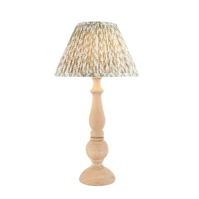 Endon Brenhurst table lamp with a hand-turned natural wood base and pleated green leaf-print fabric shade, shown on a plain white background.
