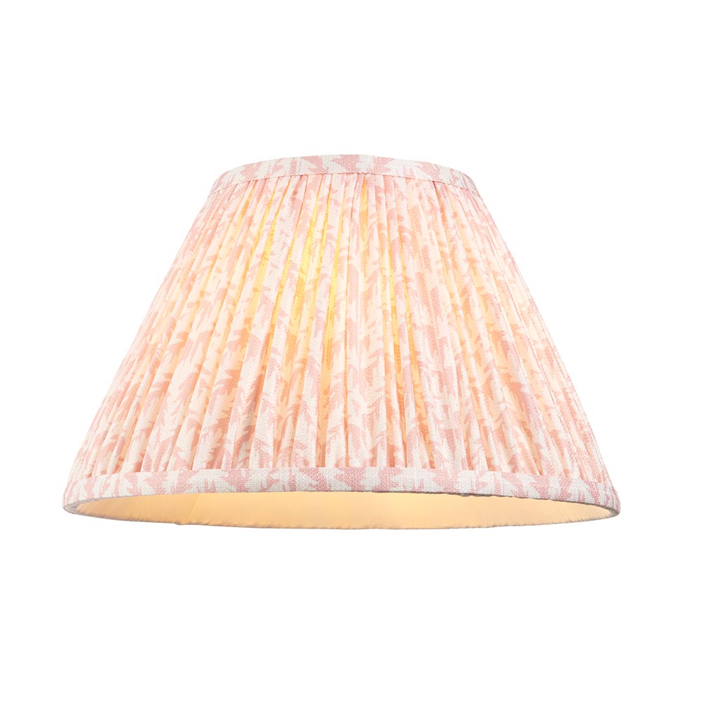Brenhurst table lamp shown close-up with pleated pink leaf-print fabric shade on a plain white background, showing brass fitting and inner lining detail.