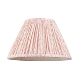 Pleated pink and white patterned fabric lamp shade shown alone on a plain white background, with brass fitting visible inside.