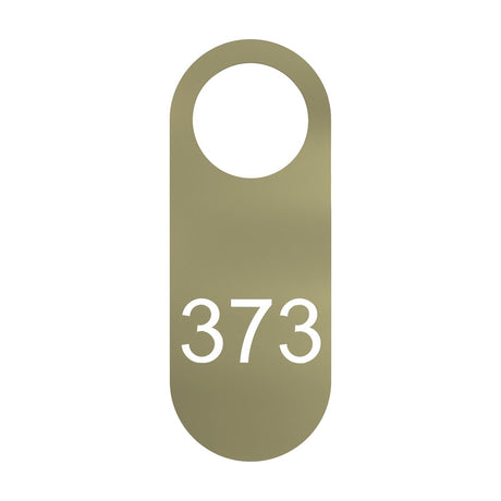 Blink Signage Tag for Wall Light in gold-finish iron, an elongated plate with rounded ends, a round top opening, and the number "373" cut through the lower half, shown on a plain white background.