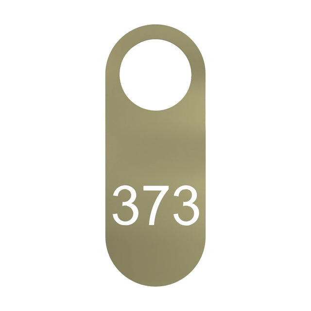 Blink Signage Tag for Wall Light in gold-finish iron, an elongated plate with rounded ends, a round top opening, and the number "373" cut through the lower half, shown on a plain white background.
