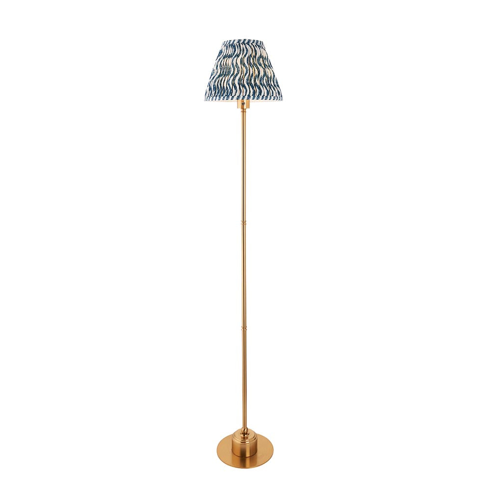 Endon Ashstead LED floor lamp with a slim brushed brass stem and blue and white ripple-print pleated fabric shade, shown on a plain white background.
