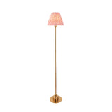 Endon Ashstead LED Ripple floor lamp with brushed aged brass stem and coral pink pleated fabric shade, shown on a plain white background.