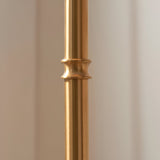Close-up of the brushed aged brass stem on the Endon Ashstead floor lamp, showing a decorative ring detail against a neutral background.