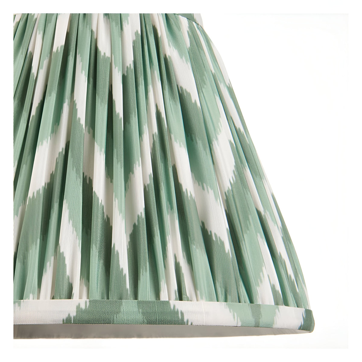 Close-up of the Endon Ashstead floor lamp's 25cm Zigzag shade in green and white pleated faux silk with taped edge detailing.