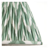 Close-up of the Endon Ashstead floor lamp's 25cm Zigzag shade in green and white pleated faux silk with taped edge detailing.