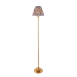 Endon Ashstead LED floor lamp with slim brushed brass stem, round base, and pleated Ikat shade in white and grey, on a plain background.