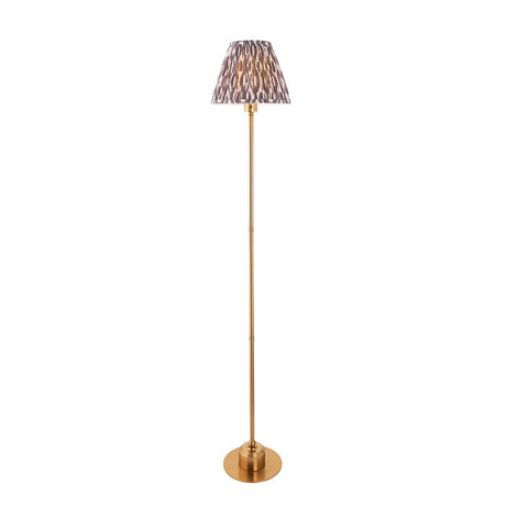 Endon Ashstead LED floor lamp with slim brushed brass stem, round base, and pleated Ikat shade in white and grey, on a plain background.