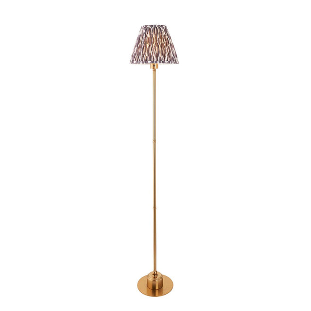Endon Ashstead LED floor lamp with slim brushed brass stem, round base, and pleated Ikat shade in white and grey, on a plain background.